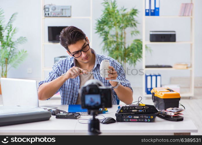 Vlogger recording computer repair on camera for vlog blog