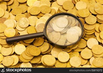 vMagnifying glass and lots of gold coins