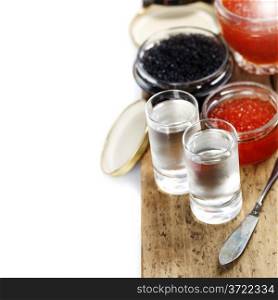 Vodka and caviar over white