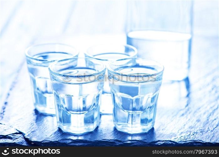 vodka into small glasses and on a table