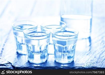 vodka into small glasses and on a table