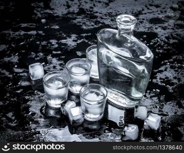 Vodka shots with ice. On the black chalkboard.. Vodka shots with ice.