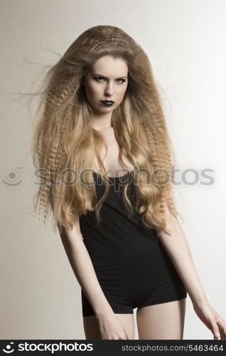 vogue portrait of fashion dark lady with long blonde flying hair-style, strong make-up and sexy black underwear