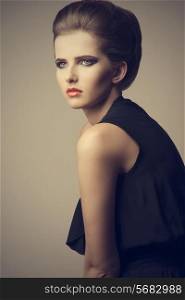 vogue sexy woman with elegant hair-style, stylish make-up and trendy black dress