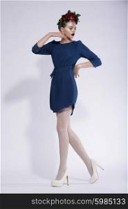 Vogue style photo of young lady posing in a blue dress.