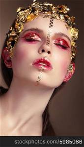 Vogue style portrait of a woman with gold makeup.