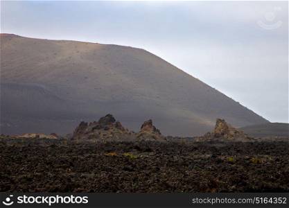 volcanic stone in los volcanes lanzarote spain timanfaya rock sky hill and summer