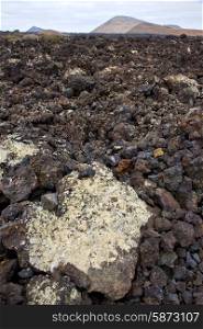 volcanic stone in los volcanes lanzarote spain timanfaya rock sky hill and summer &#xA;
