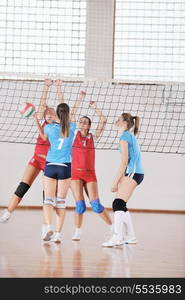 volleyball game sport with group of young beautiful girls indoor in sport arena