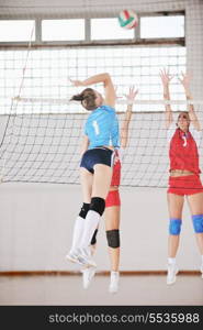 volleyball game sport with group of young beautiful girls indoor in sport arena