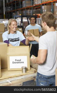 Volunteers Collecting Food Donations In Warehouse