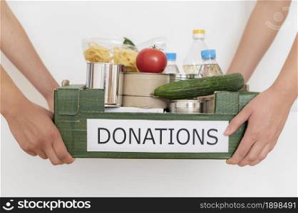 volunteers holding box filled with food donation. Resolution and high quality beautiful photo. volunteers holding box filled with food donation. High quality beautiful photo concept
