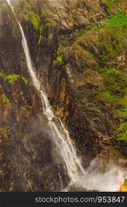 Voringsfossen waterfall, green summer mountains, Mabodalen canyon Norway. National tourist Hardangervidda route, touristroad Rv7, Eidfjord sightseeing tour.. Voringsfossen waterfall, Mabodalen canyon Norway