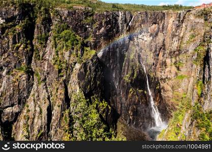 Voringsfossen waterfall with rainbow in summer, Mabodalen valley Norway. National tourist Hardangervidda route, touristroad 7, Eidfjord sightseeing tour.. Voringsfossen waterfall, Hardangervidda route, Norway
