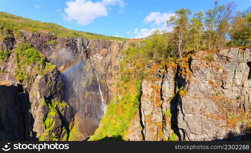 Voringsfossen waterfall with rainbow in summer, Mabodalen valley Norway. National tourist Hardangervidda route, touristroad 7, Eidfjord sightseeing tour.. Voringsfossen waterfall with rainbow, Norway