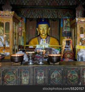 Votive candles burning in front of Buddha statue in Drepung Monastery, Lhasa, Tibet, China