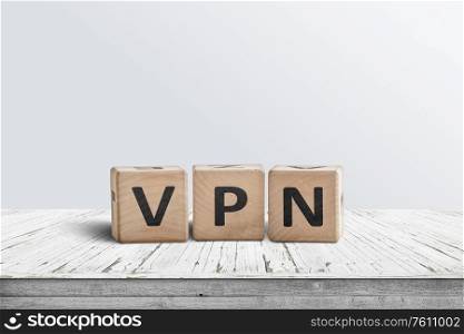 VPN word on wooden block sign in a bright room on a worn table