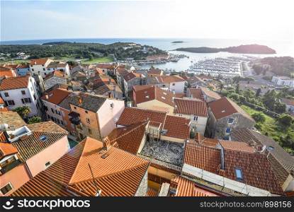 Vrsar, Croatia - May 20, 2018: View on old red roofs of small Croatian town Vrsar, yachts and the mediterranean sea, Croatia. View on old red roofs of small Croatian town Vrsar, Croatia