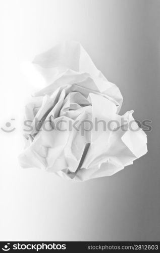 wad of paper on grey background