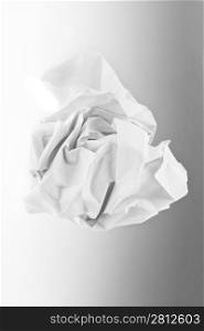 wad of paper on grey background