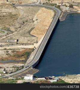 Wadi Mujib dam with a road for public transport in Jordan, middle east