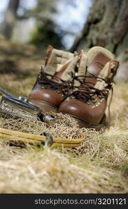 Wading boots with a fishing net and a fishing reel