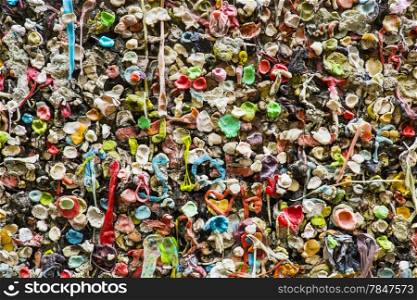 Wads of chewed bubble gum are stuck to the gum wall near the Pike Place Market in Seattle. The wall is a local landmark.