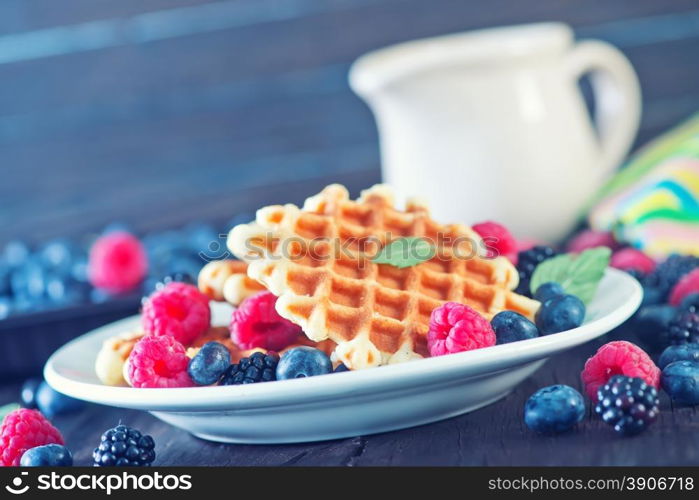 wafels with berry and fresh milk on a table