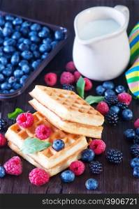 wafels with berry and fresh milk on a table