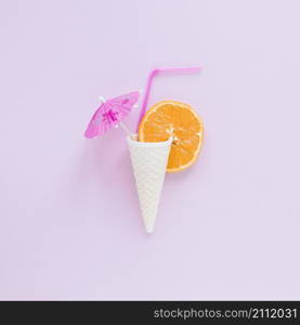 waffle cone with orange straw umbrella table