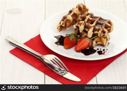 Waffle dessert with chocolate sauce and strawberry