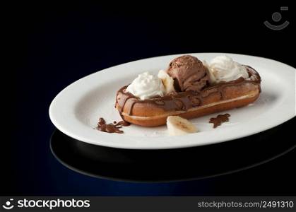 Waffles and ice cream in a dish on a dark background. Waffles and ice cream in a dish