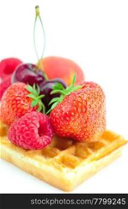 waffles,apricot, cherries, strawberries and raspberries isolated on white