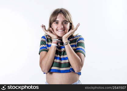 Waist up portrait of a happy attractive girl holding her hands on her neck, smiling and looking at the camera isolated over white background