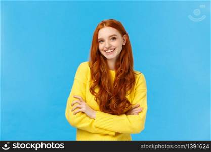 Waist-up shot fashionable pretty hipster girl with red hair, blue eyes, freckles, smiling lovely with cheerful expression, hold hands crossed over chest, confident professional pose, blue background.. Waist-up shot fashionable pretty hipster girl with red hair, blue eyes, freckles, smiling lovely with cheerful expression, hold hands crossed over chest, confident professional pose, blue background