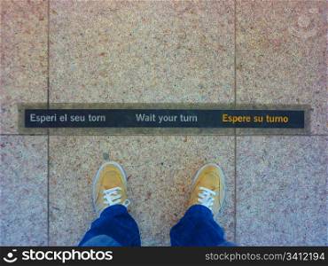 Wait your turn sign, in Barcellona airport. A clear concept