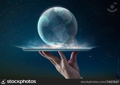 Waiter hand using digital pad holding digital glass planet earth with hologram design . Global business technologies concept. Mixed media .