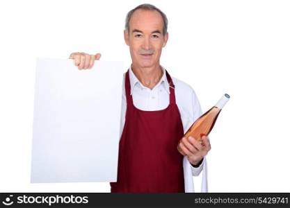 waiter holding a bottle of wine and an empty board