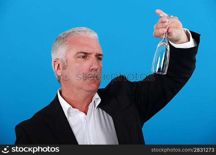 waiter holding flute upside down