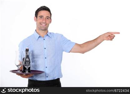 Waiter holding tray with beef bottle on it