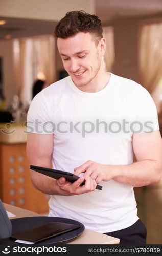 Waiter In Hotel Using Digital Tablet