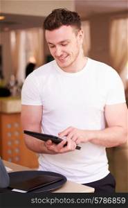 Waiter In Hotel Using Digital Tablet