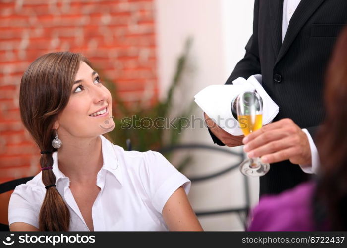 Waiter pouring champagne