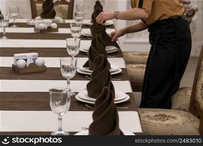 waiter serves a banquet table in a luxurious restaurant. served table in the restaurant