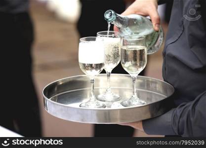 Waiter serving champagne at party