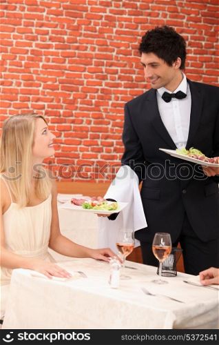 Waiter serving lunch