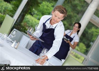 waiter setting wedding table at restaurant