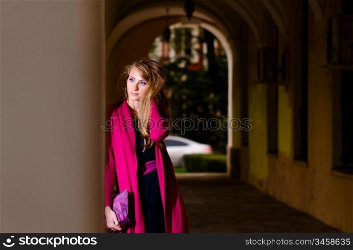waiting woman in trendy dress is standing on street