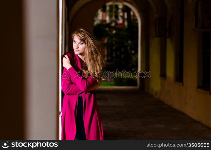 waiting woman in trendy dress is standing on street