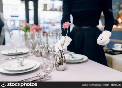 Waitress against empty tableware, table setting. Serving service, festive dinner decoration, holiday dinnerware
